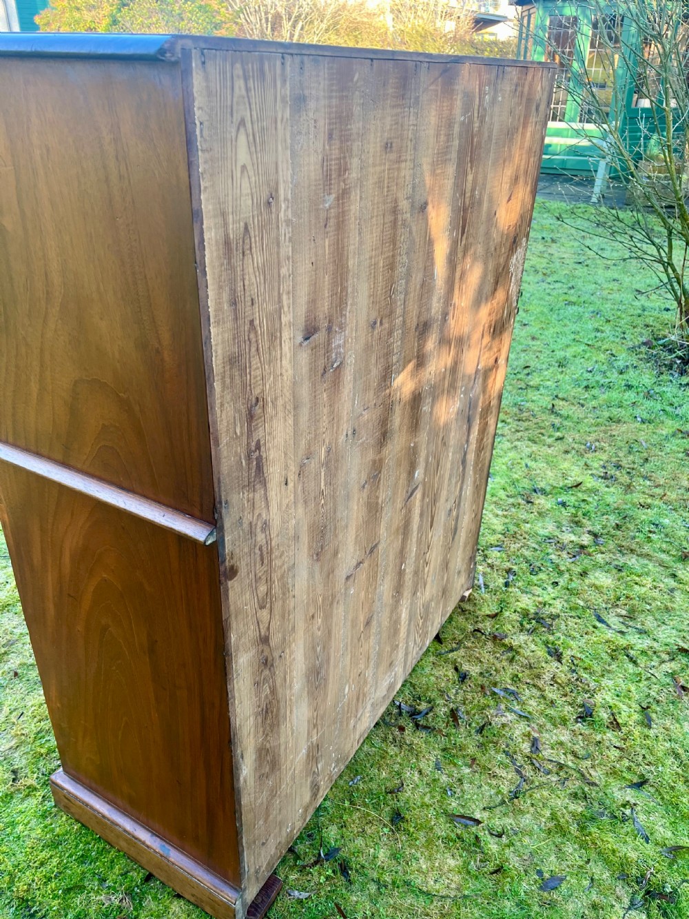 A two-part warm brown mahogany campaign cabinet featuring four panelled sliding doors with flush-fitting brass pull handles. View VIII