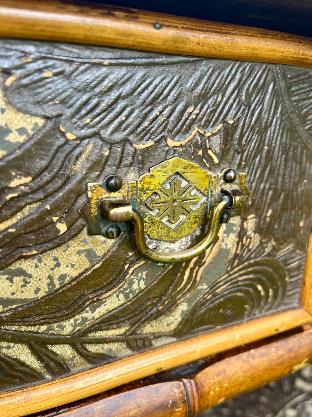 A late Victorian bamboo display cabinet with two glazed doors, upper drawers, and dark embossed botanical pattern panels. View IX