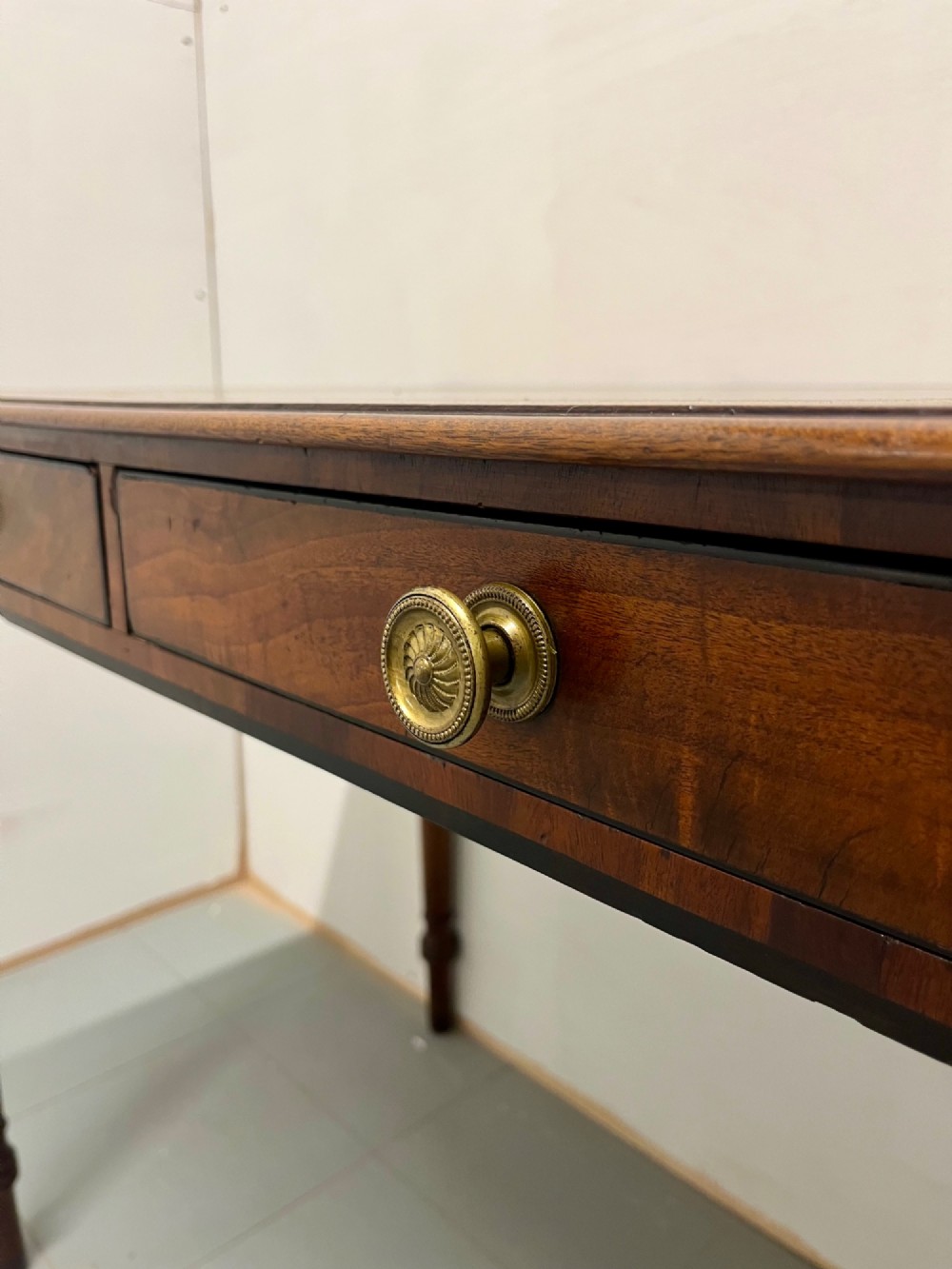 A Scottish Regency mahogany side table featuring two frieze drawers with brass handles and slender turned legs. View V