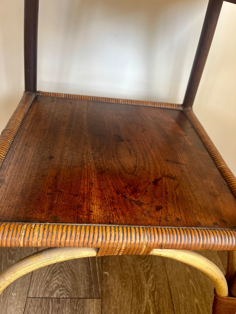 A square two-tier Dryad cane occasional table with a clear glass top, brass corner mounts, dark wood lower shelf, and woven tapered legs. View III