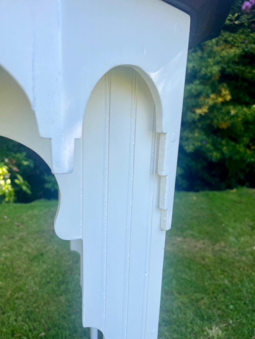 A white painted Moorish style occasional table featuring stepped horseshoe arches and a dark contrasting tray top. View IV
