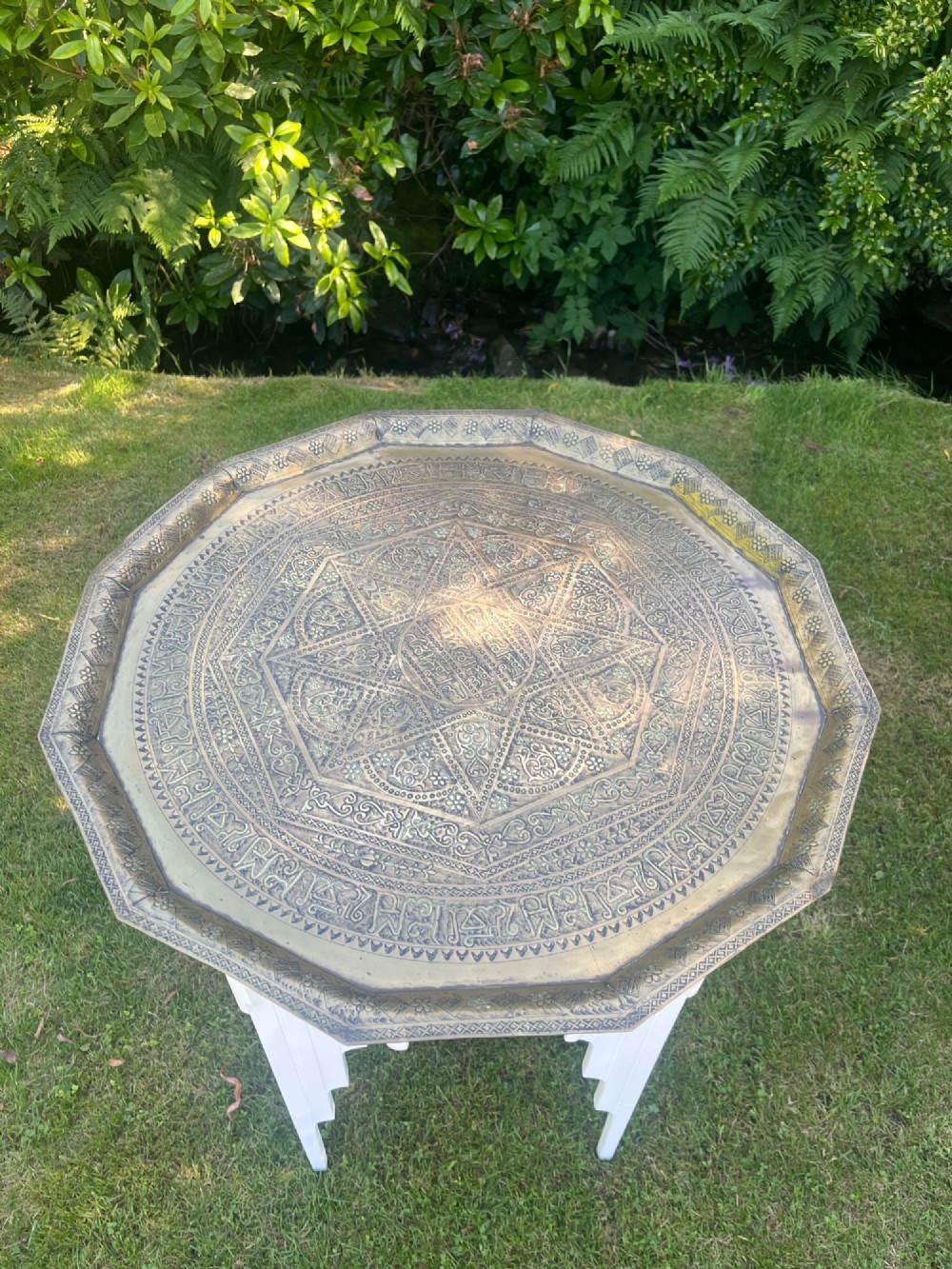 A white painted Moorish style occasional table featuring stepped horseshoe arches and a dark contrasting tray top. View VII