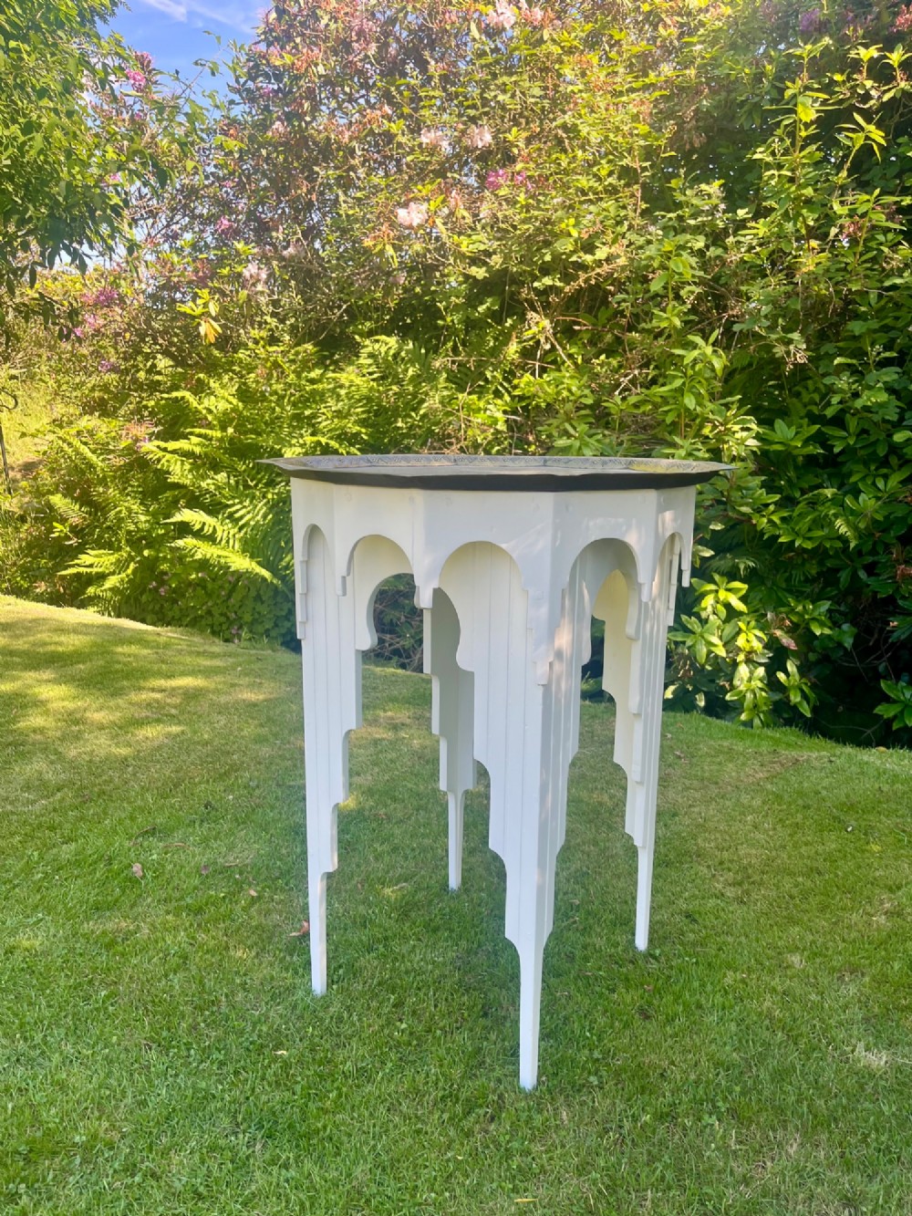 A white painted Moorish style occasional table featuring stepped horseshoe arches and a dark contrasting tray top. View X