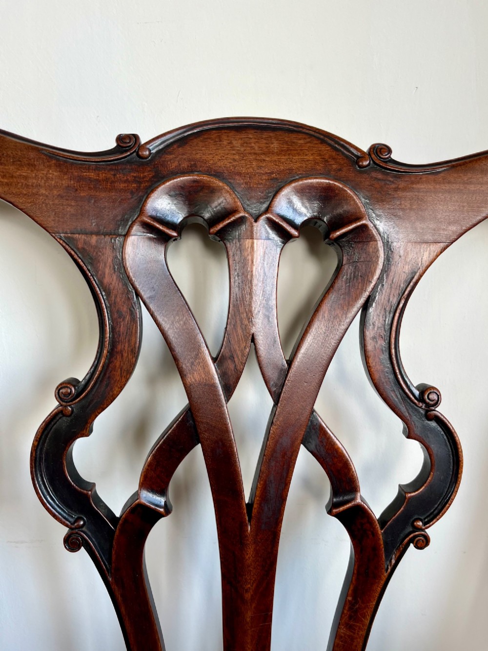 A Georgian Chippendale mahogany open armchair featuring a hand-carved pierced splat back, shaped armrests, square legs, and a floral tapestry upholstered seat. View III