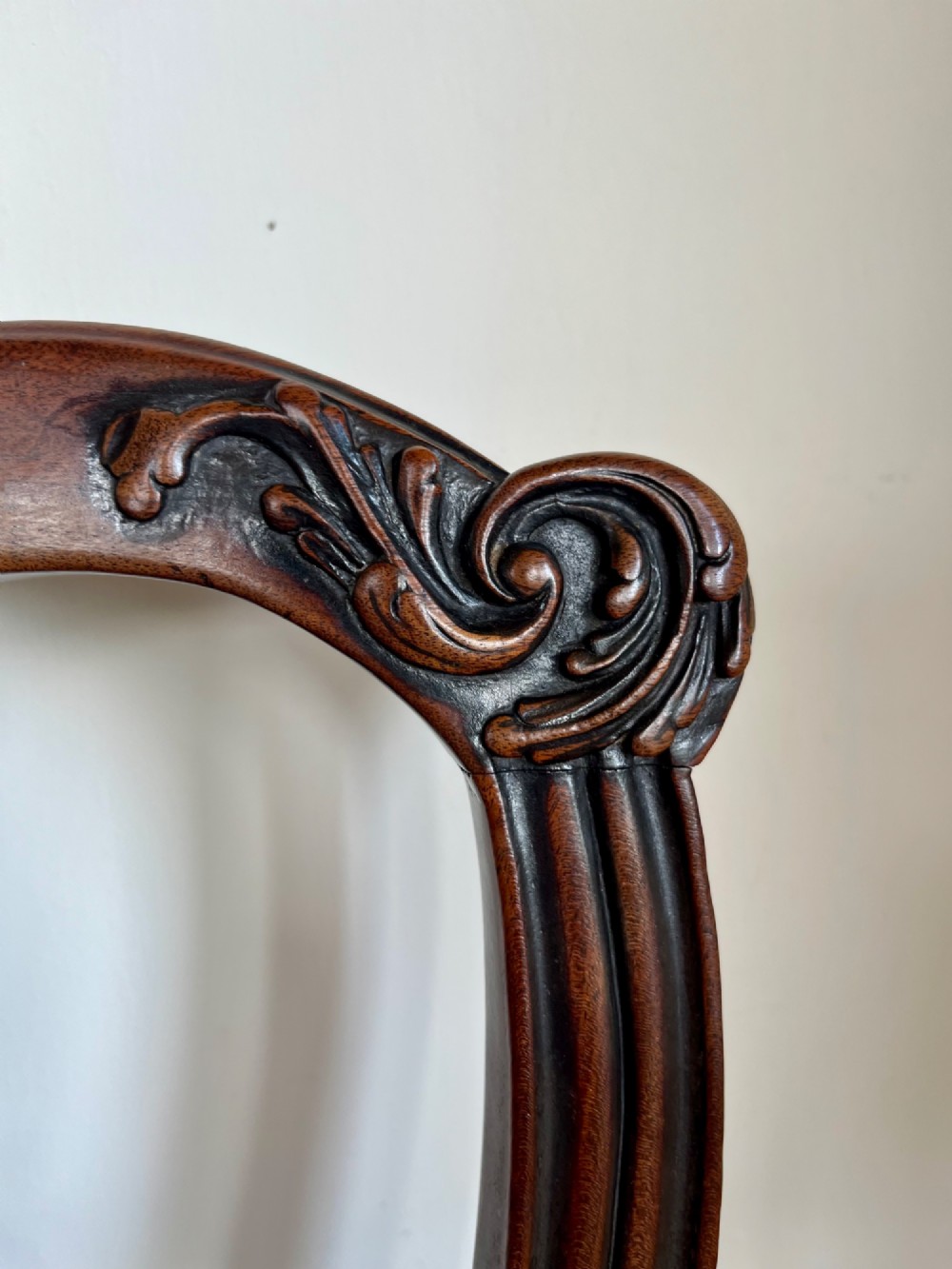 A Georgian Chippendale mahogany open armchair featuring a hand-carved pierced splat back, shaped armrests, square legs, and a floral tapestry upholstered seat. View IV