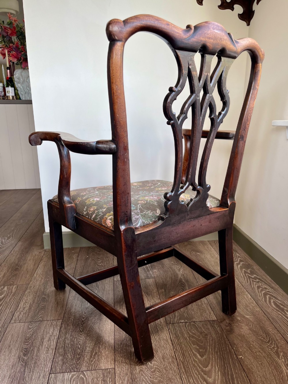A Georgian Chippendale mahogany open armchair featuring a hand-carved pierced splat back, shaped armrests, square legs, and a floral tapestry upholstered seat. View VII