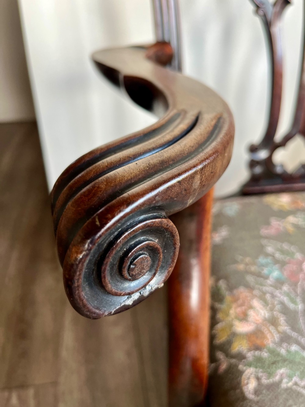 A Georgian Chippendale mahogany open armchair featuring a hand-carved pierced splat back, shaped armrests, square legs, and a floral tapestry upholstered seat. View IX