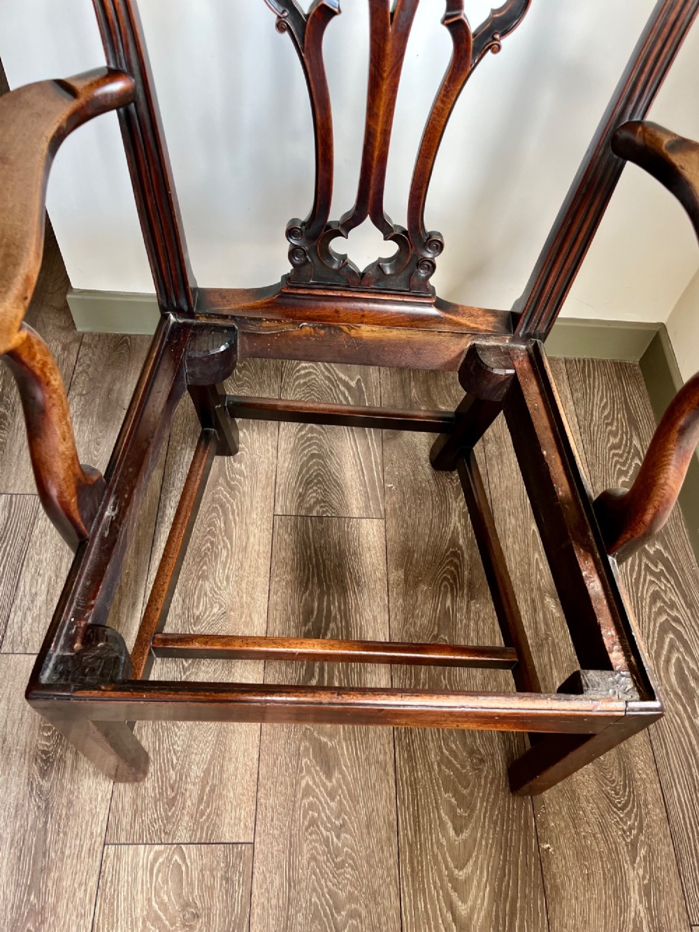 A Georgian Chippendale mahogany open armchair featuring a hand-carved pierced splat back, shaped armrests, square legs, and a floral tapestry upholstered seat. View X