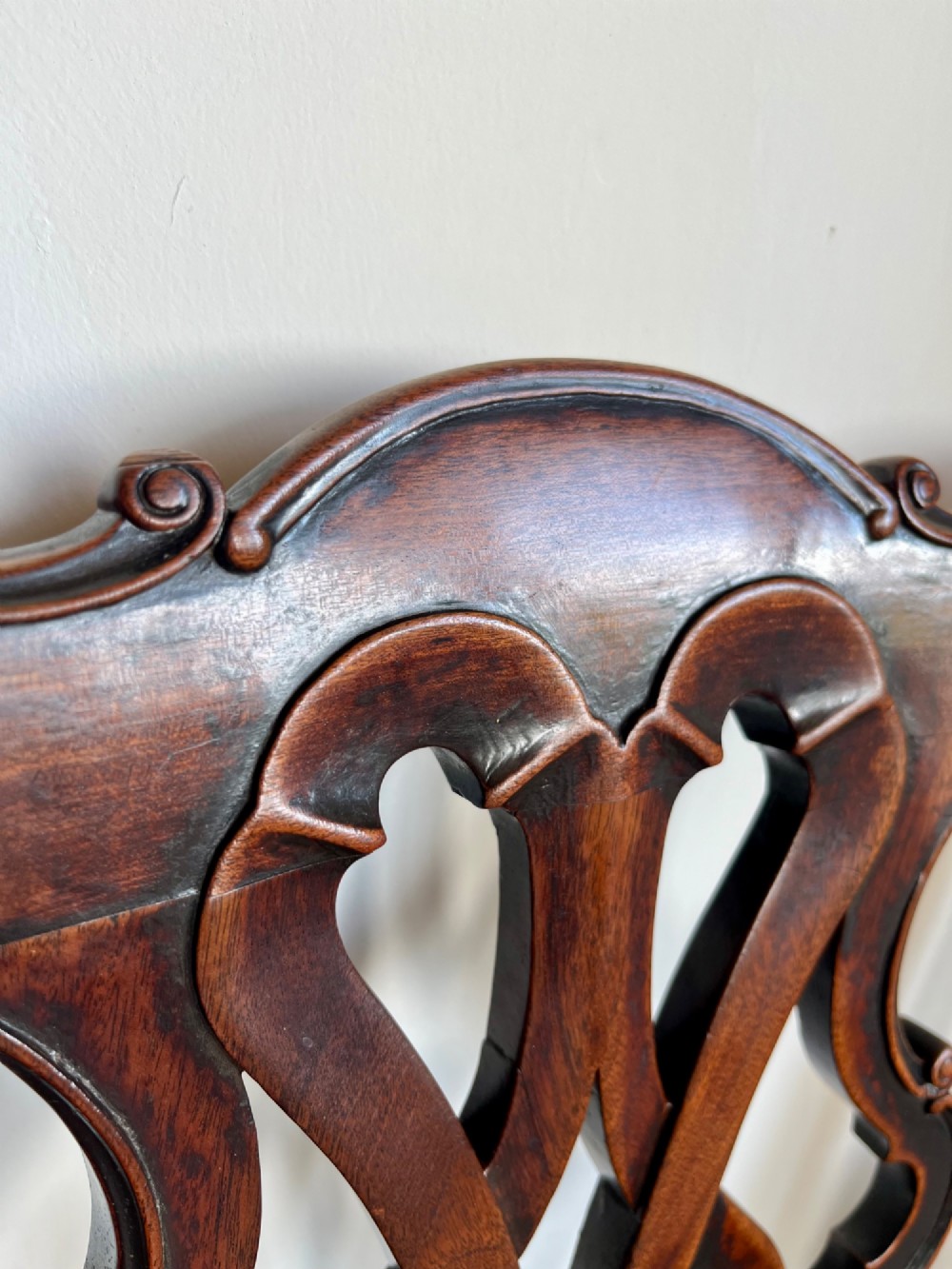 A Georgian Chippendale mahogany open armchair featuring a hand-carved pierced splat back, shaped armrests, square legs, and a floral tapestry upholstered seat. View XI