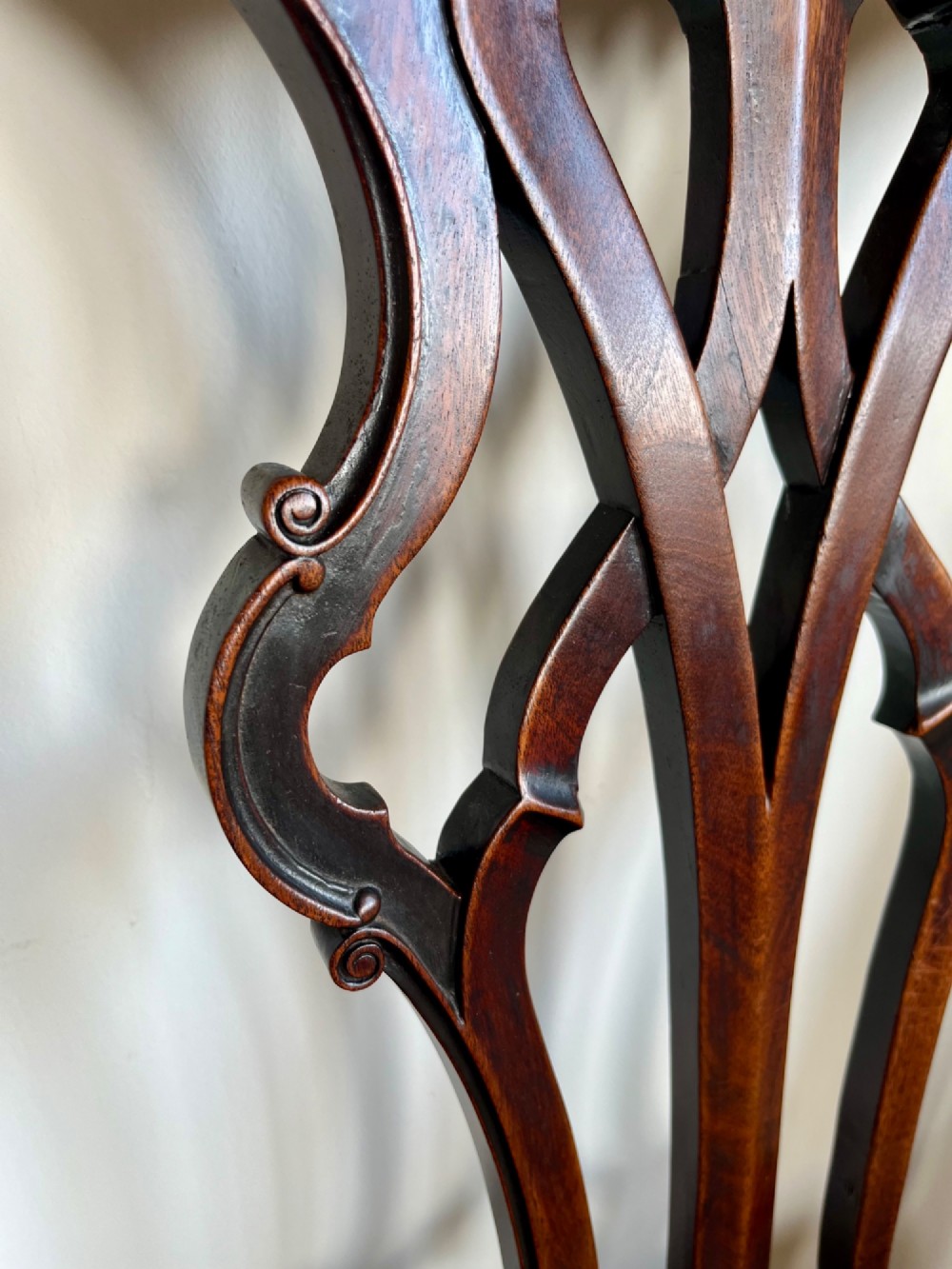 A Georgian Chippendale mahogany open armchair featuring a hand-carved pierced splat back, shaped armrests, square legs, and a floral tapestry upholstered seat. View XII