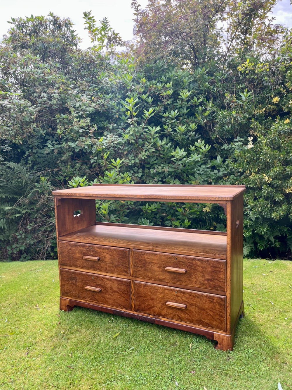 An elm wood side cabinet with an open upper shelf and four drawers featuring integrated wooden handles.