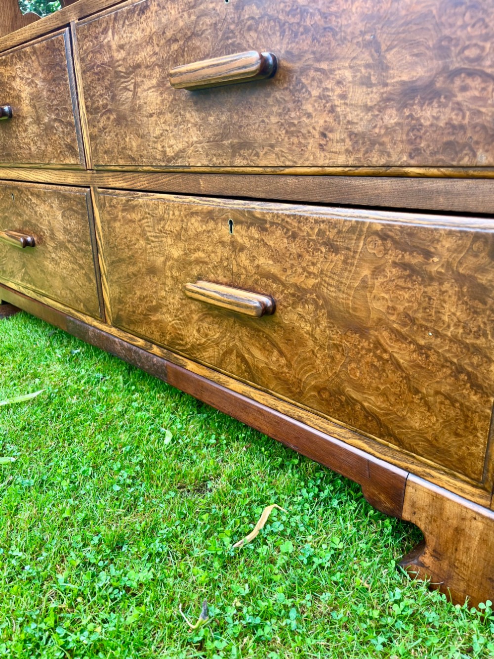 An elm wood side cabinet with an open upper shelf and four drawers featuring integrated wooden handles. View II