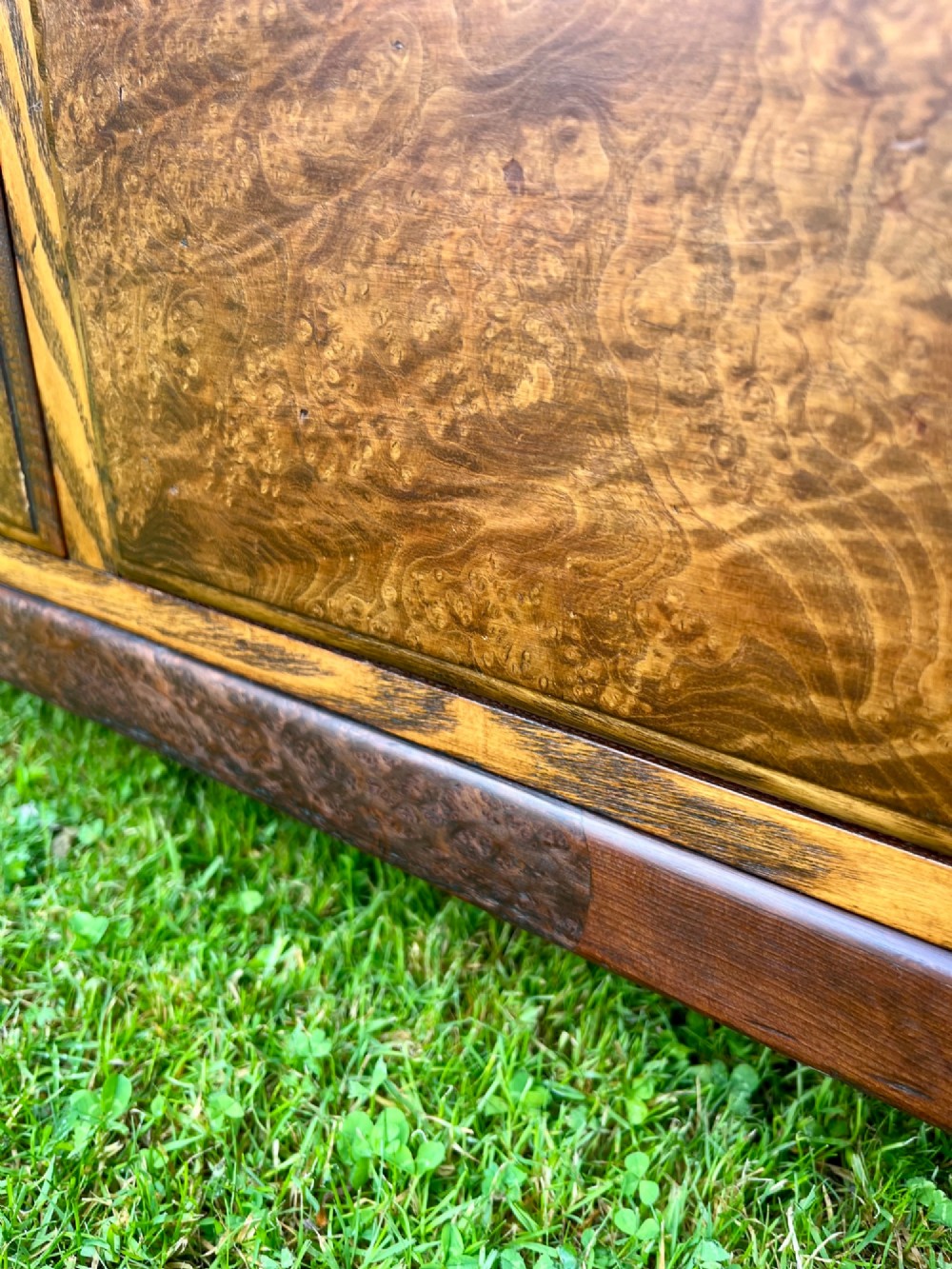 An elm wood side cabinet with an open upper shelf and four drawers featuring integrated wooden handles. View III