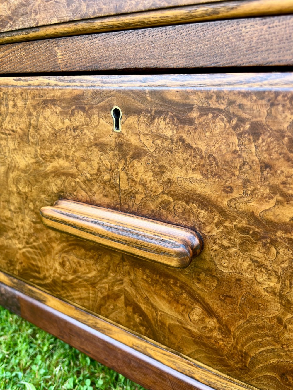 An elm wood side cabinet with an open upper shelf and four drawers featuring integrated wooden handles. View IV