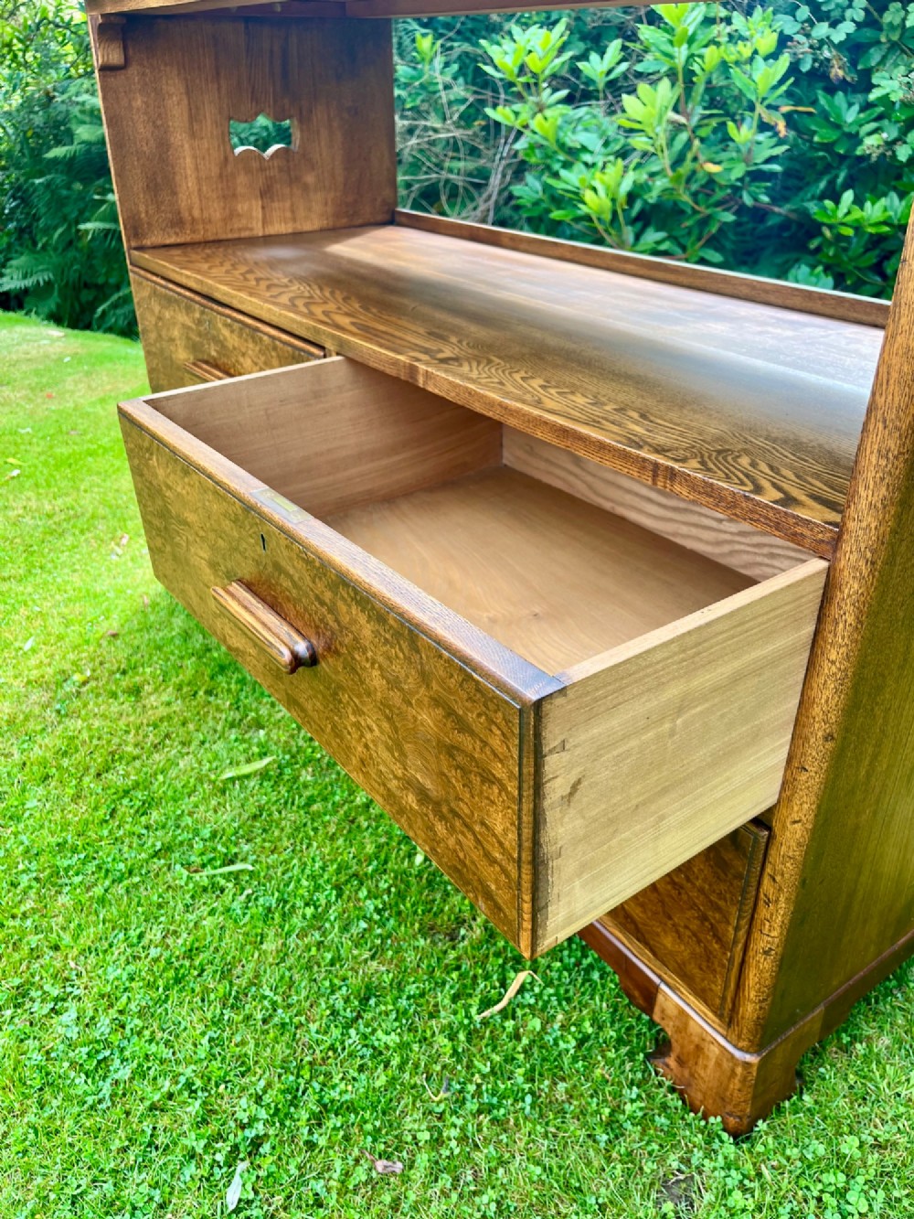 An elm wood side cabinet with an open upper shelf and four drawers featuring integrated wooden handles. View V