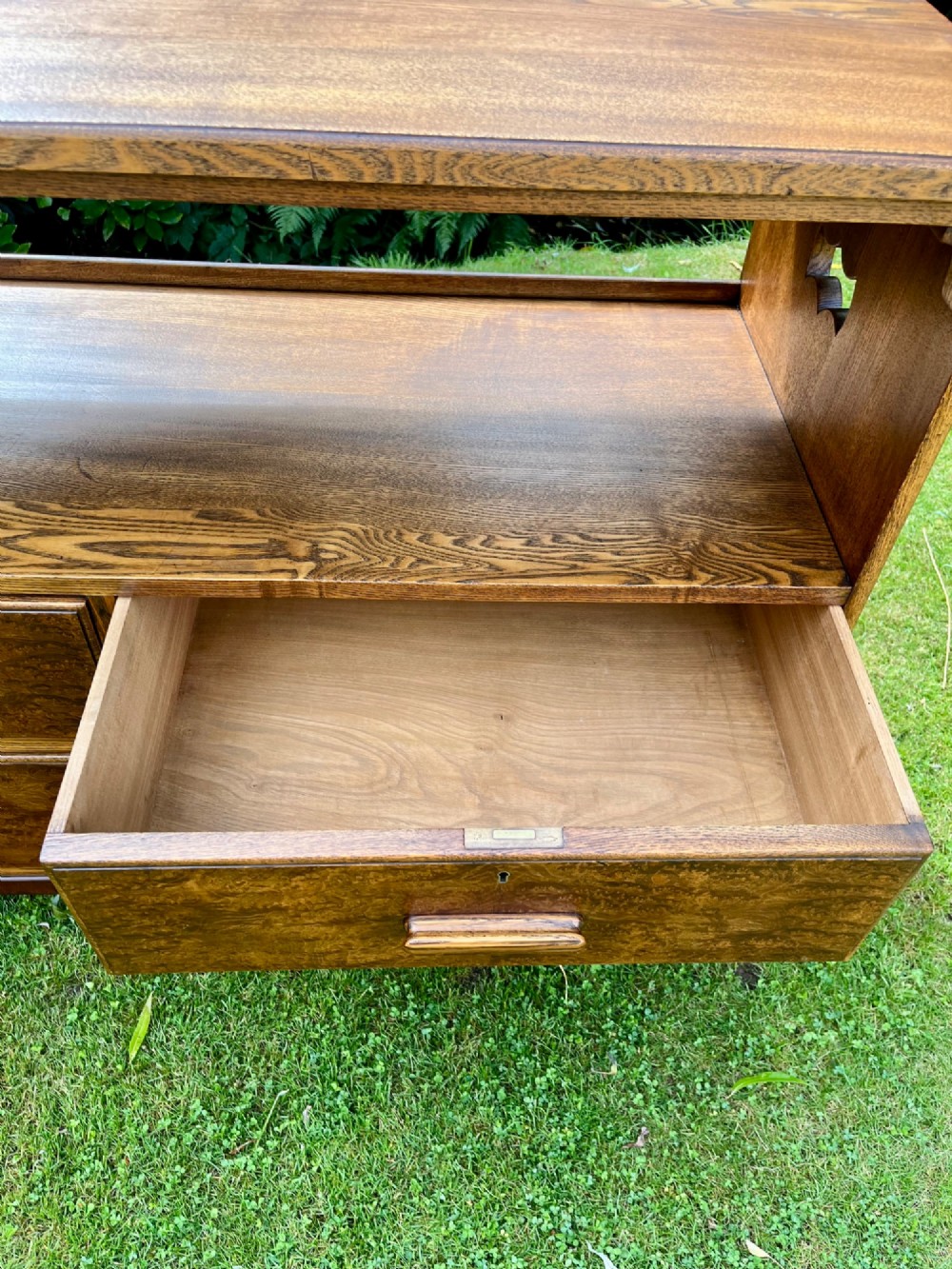 An elm wood side cabinet with an open upper shelf and four drawers featuring integrated wooden handles. View VI