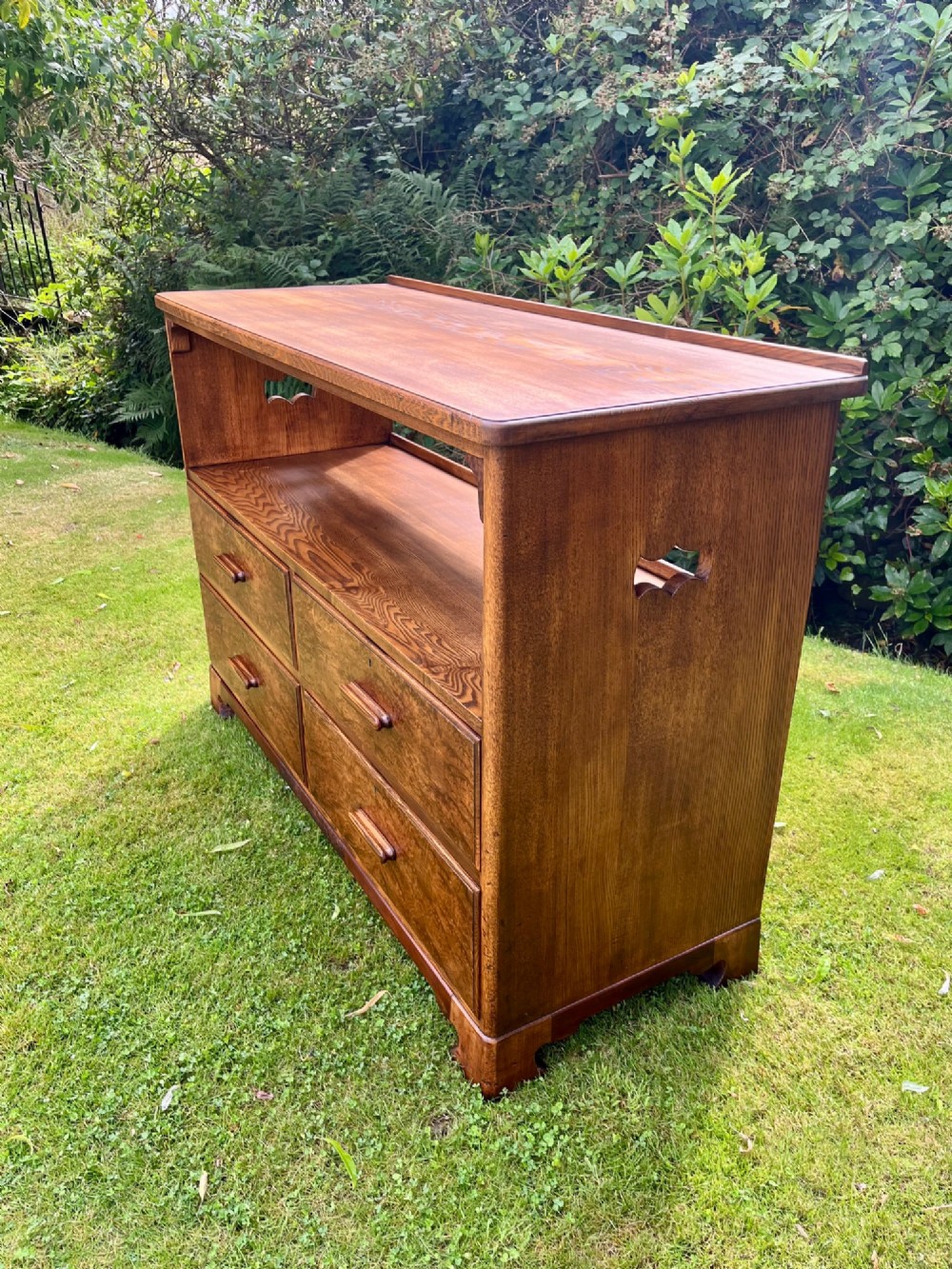 An elm wood side cabinet with an open upper shelf and four drawers featuring integrated wooden handles. View VII