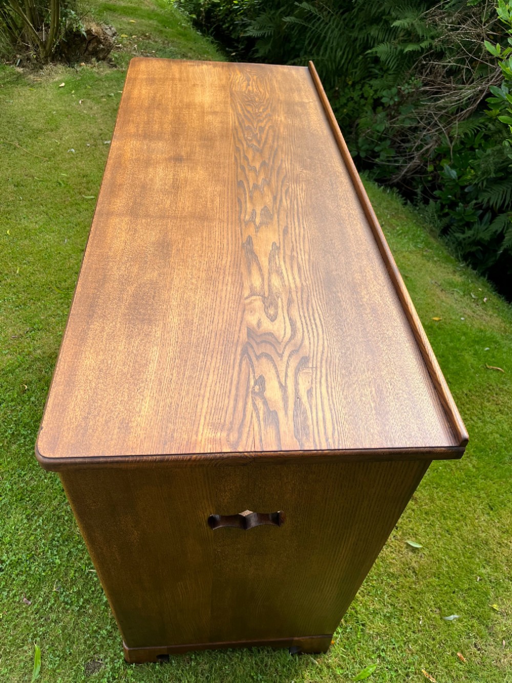 An elm wood side cabinet with an open upper shelf and four drawers featuring integrated wooden handles. View VIII