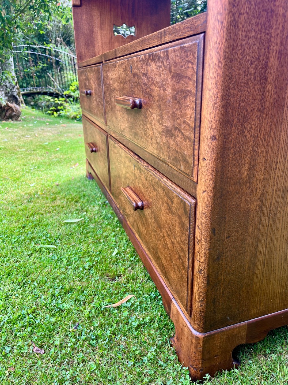 An elm wood side cabinet with an open upper shelf and four drawers featuring integrated wooden handles. View X