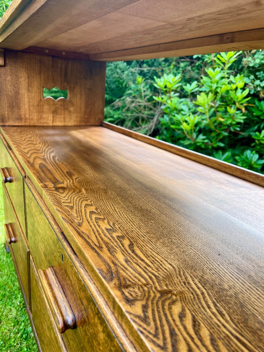 An elm wood side cabinet with an open upper shelf and four drawers featuring integrated wooden handles. View XI