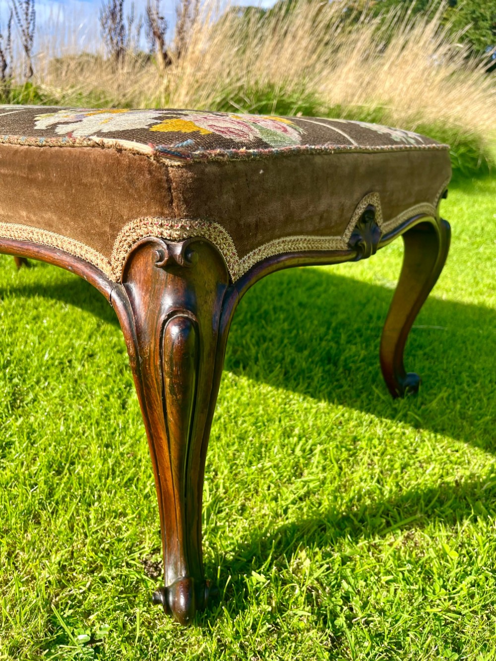 A long rectangular Victorian centre stool with dark rosewood cabriole legs and floral tapestry upholstery set in brown velvet. View III