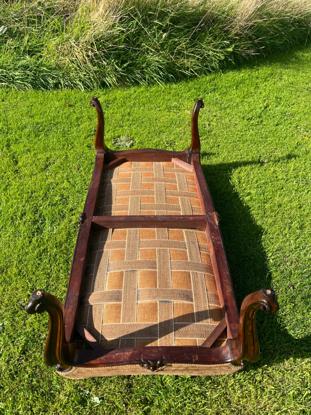 A long rectangular Victorian centre stool with dark rosewood cabriole legs and floral tapestry upholstery set in brown velvet. View X