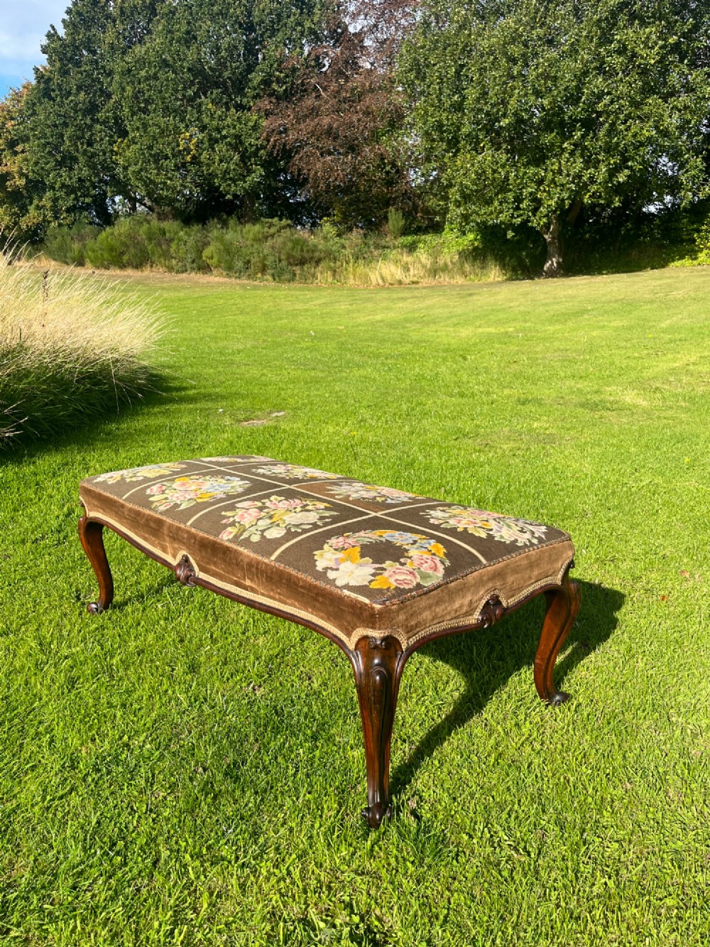 A long rectangular Victorian centre stool with dark rosewood cabriole legs and floral tapestry upholstery set in brown velvet. View XII