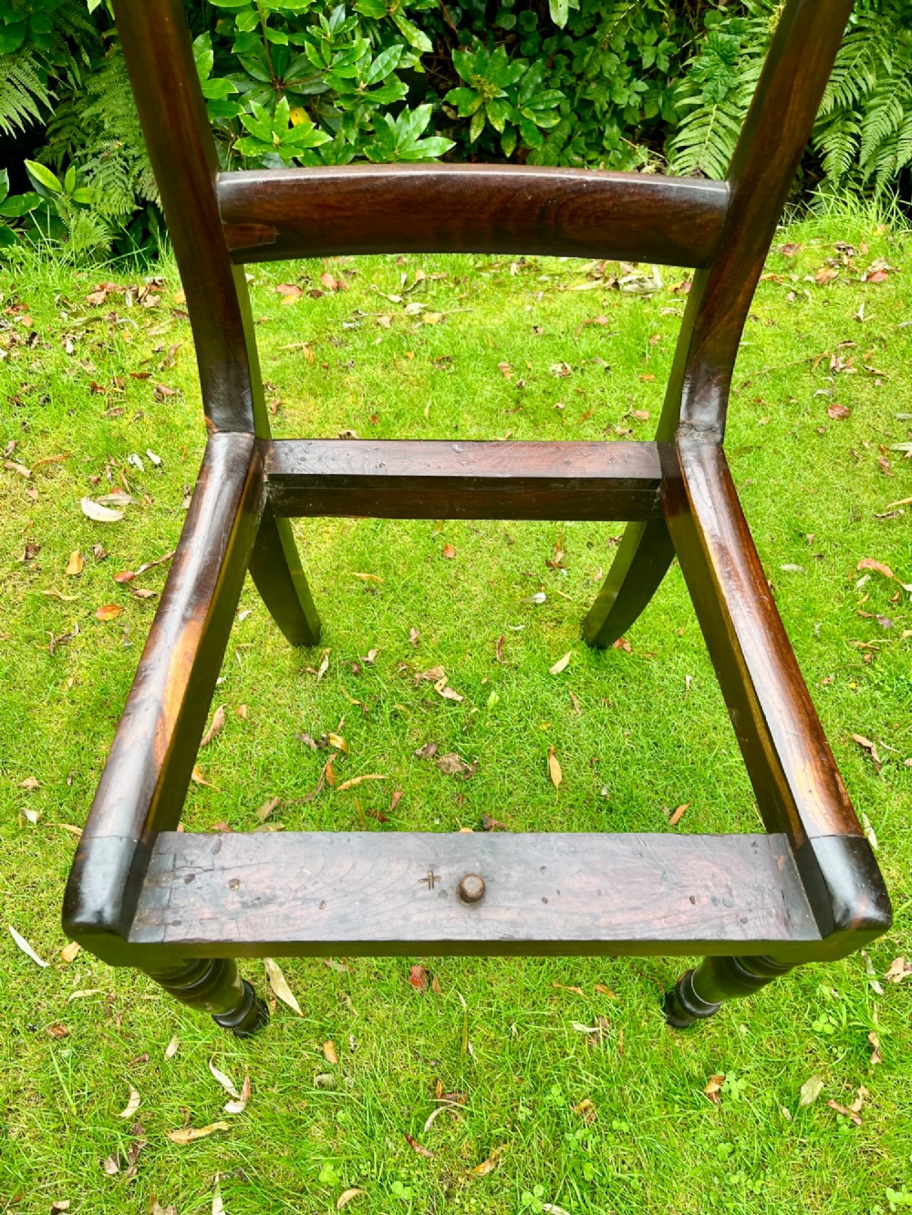 A pair of dark brown laburnum wooden side chairs featuring turned front legs, curved top rails, and open frames for drop-in seats. View VII