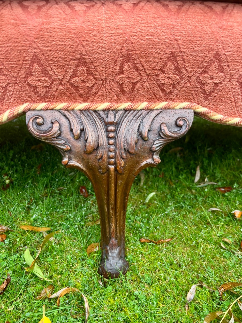 A terracotta upholstered camel back sofa featuring carved mahogany cabriole legs and twin seat cushions. View IV