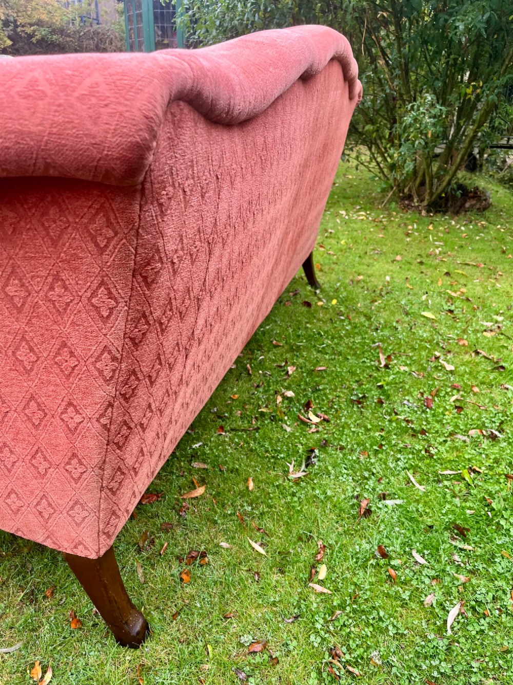 A terracotta upholstered camel back sofa featuring carved mahogany cabriole legs and twin seat cushions. View VII