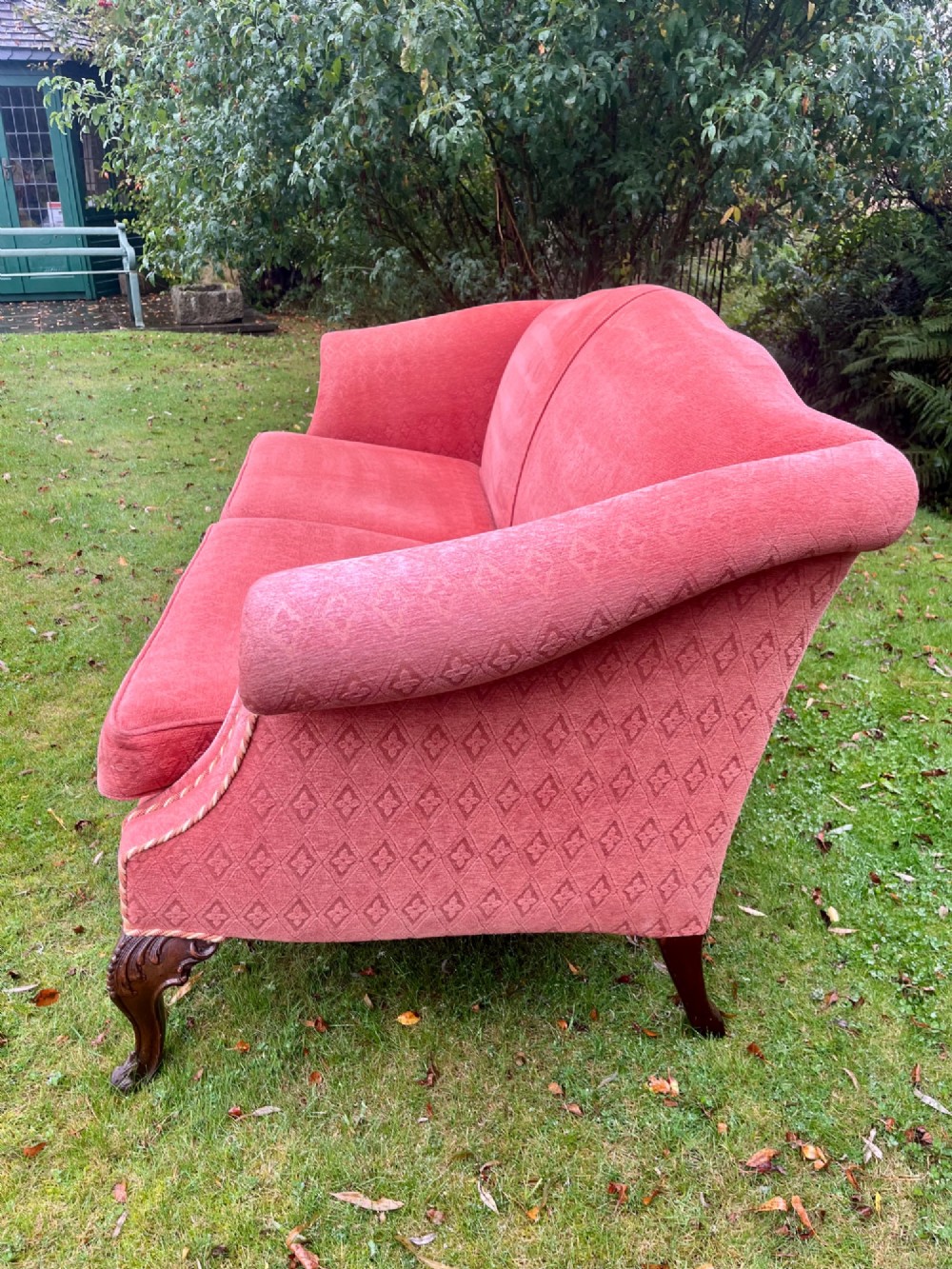 A terracotta upholstered camel back sofa featuring carved mahogany cabriole legs and twin seat cushions. View VIII