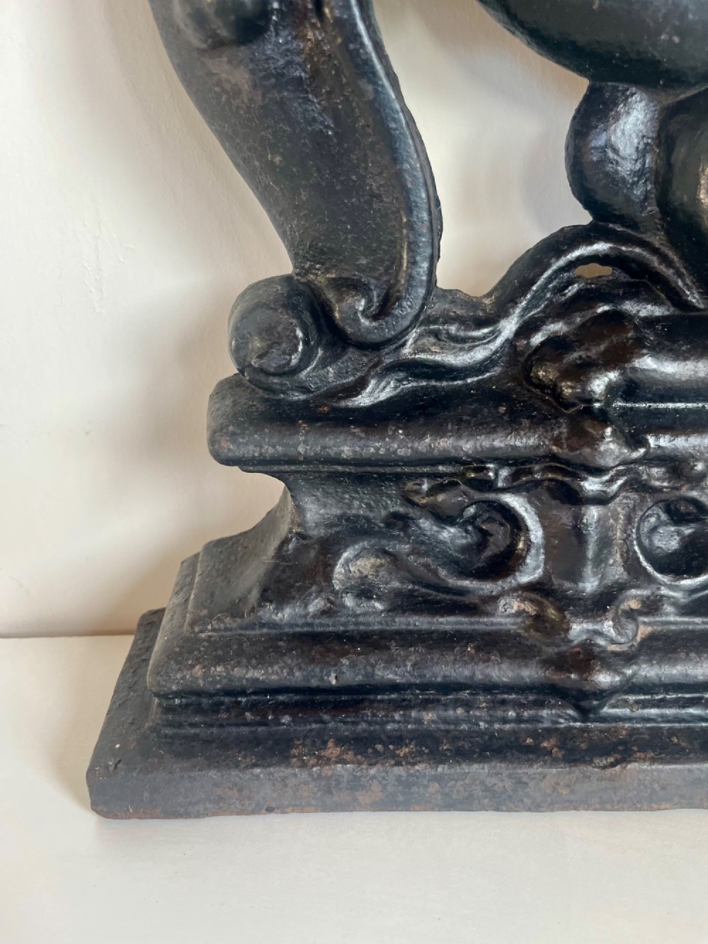 A heavy black cast iron door porter depicting a heraldic lion rampant on a stepped rectangular plinth base. View IV
