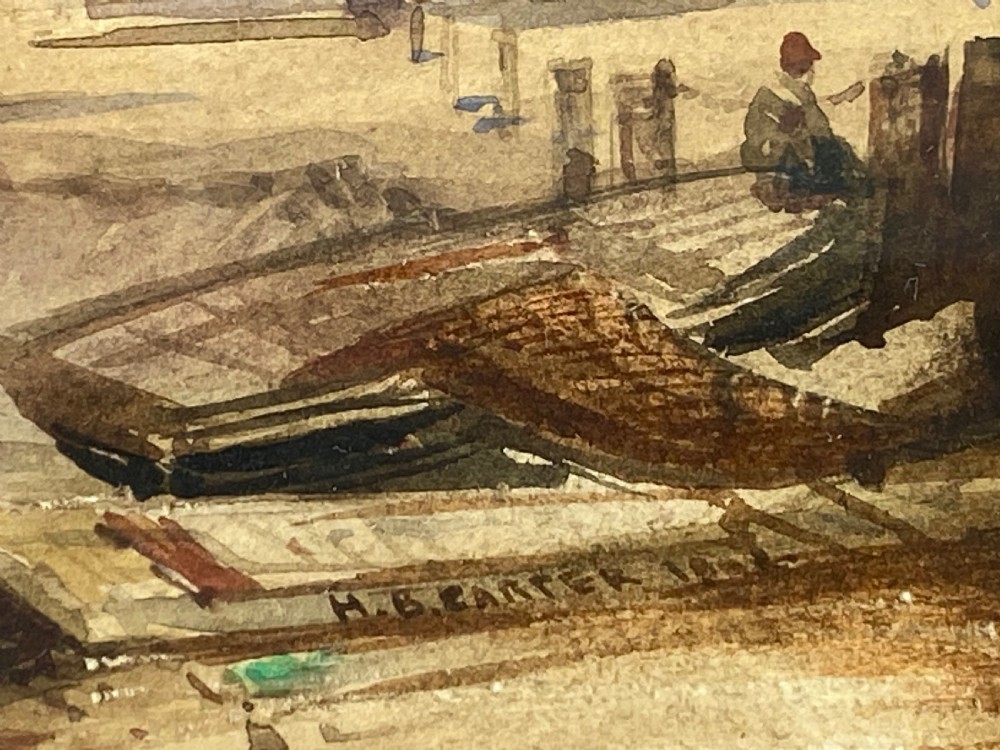 A 19th-century watercolour painting depicting a coastal town and harbour scene with rough seas, set inside a heavy gold gilt scrollwork frame. View II