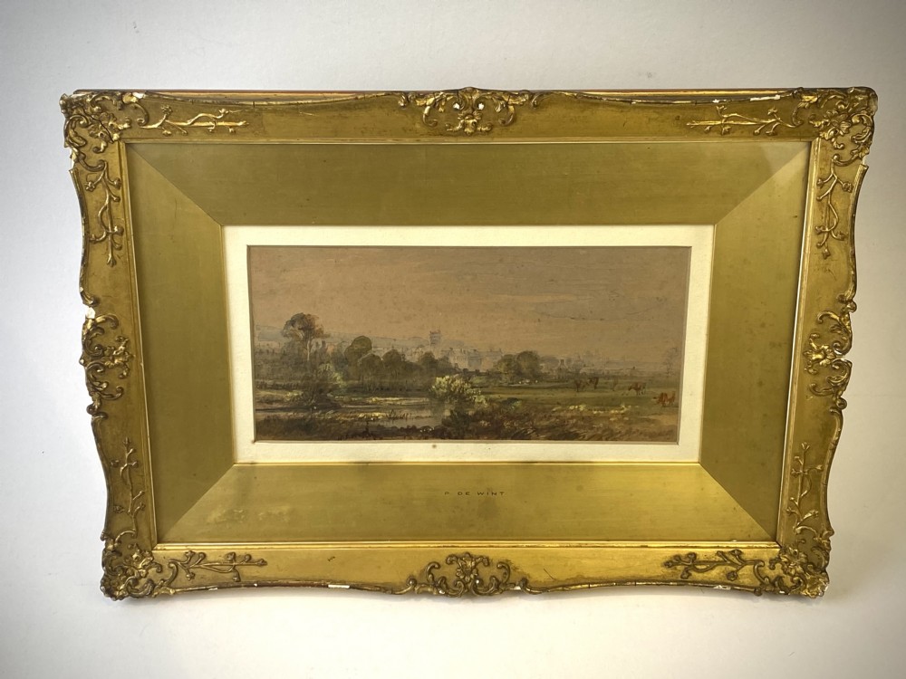 A 19th-century framed watercolour depicting an English rural landscape set within a broad gilt frame.