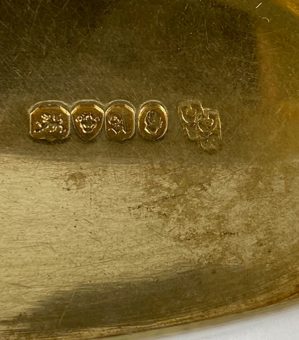 An open oval sterling silver snuff box displaying a gilded interior and hallmarks inside the lid. View III