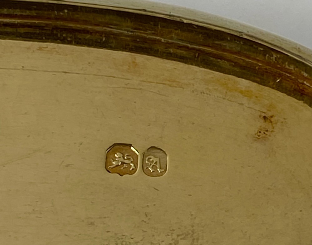 An open oval sterling silver snuff box displaying a gilded interior and hallmarks inside the lid. View VI