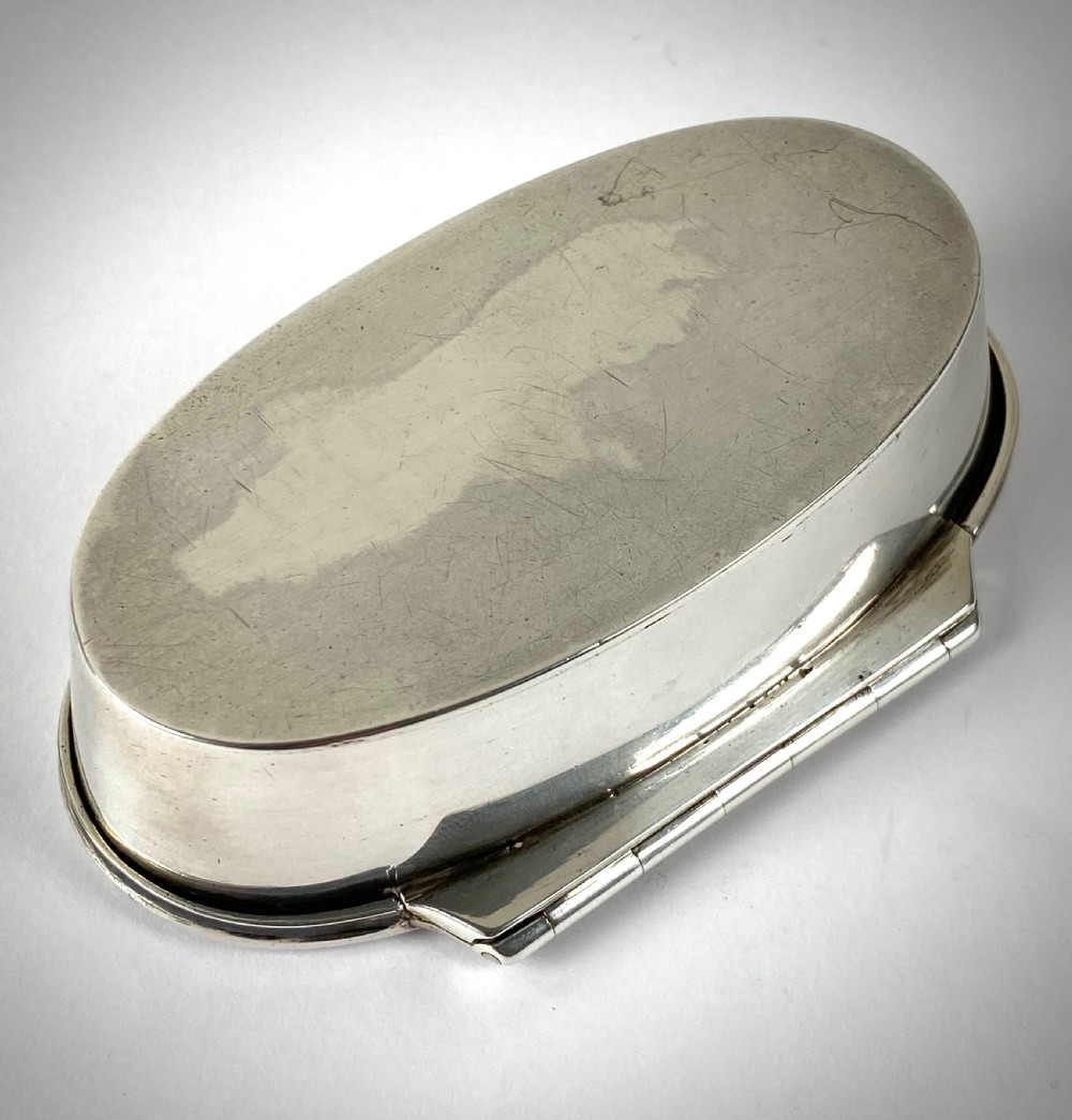 An open oval sterling silver snuff box displaying a gilded interior and hallmarks inside the lid. View VII