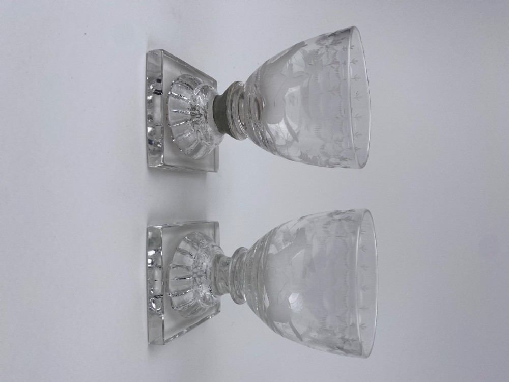 Clear glass rummer featuring an etched hunting scene of fox and hounds, supported by a ribbed stem and a square press-moulded lemon squeezer base. View VI