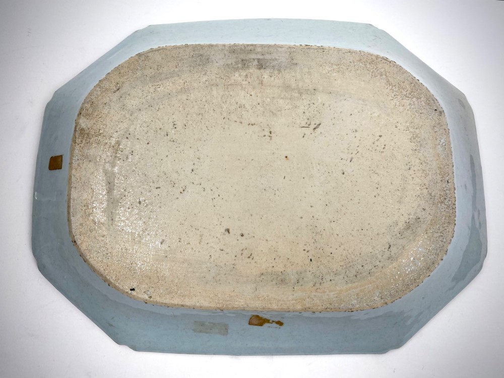 An 18th-century octagonal Chinese export porcelain platter painted in underglaze cobalt blue with a central scene of two deer under a pine tree surrounded by a patterned border. View III