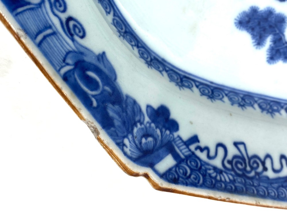 An 18th-century octagonal Chinese export porcelain platter painted in underglaze cobalt blue with a central scene of two deer under a pine tree surrounded by a patterned border. View IV