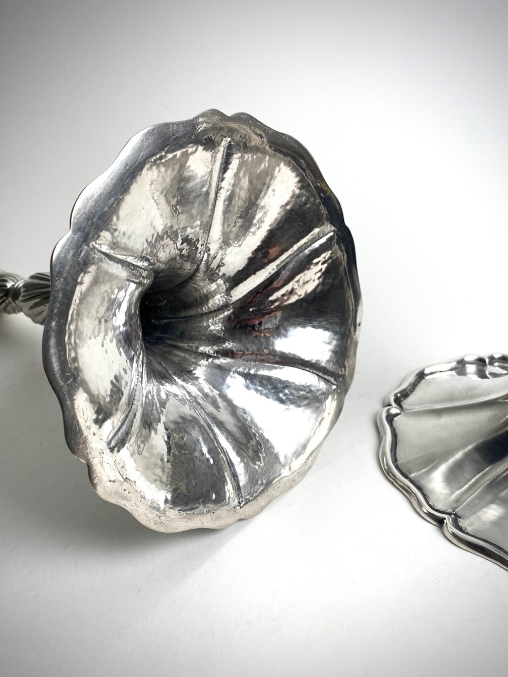 A pair of polished sterling silver candlesticks featuring spiral-twisted stems and wide, lobed flared bases. View III