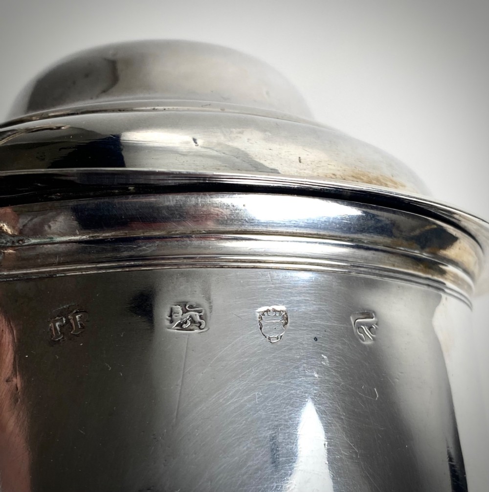 A Georgian sterling silver lidded tankard featuring a domed cap, thumbpiece, scrolled handle, and moulded girdle. View III