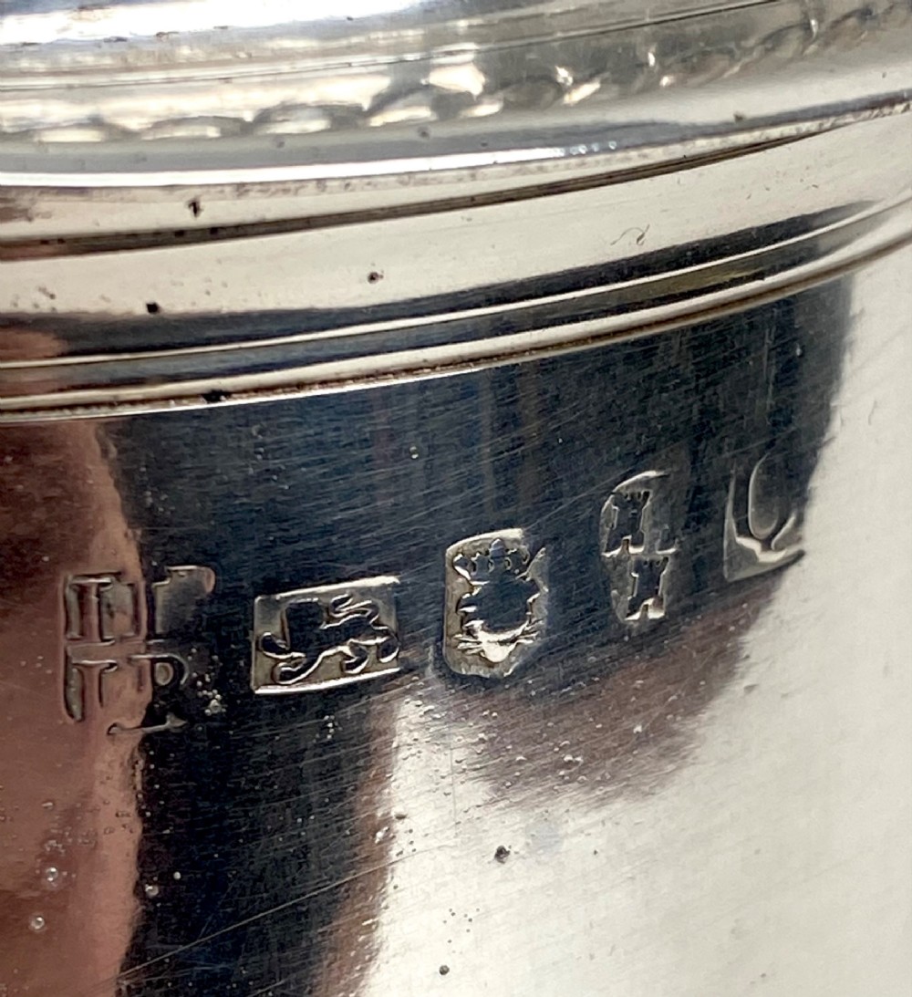 A sterling silver lidded tankard featuring spiralled fluted ornamentation along the lower body, gadrooned borders, a scroll handle, and stamped hallmarks. View III