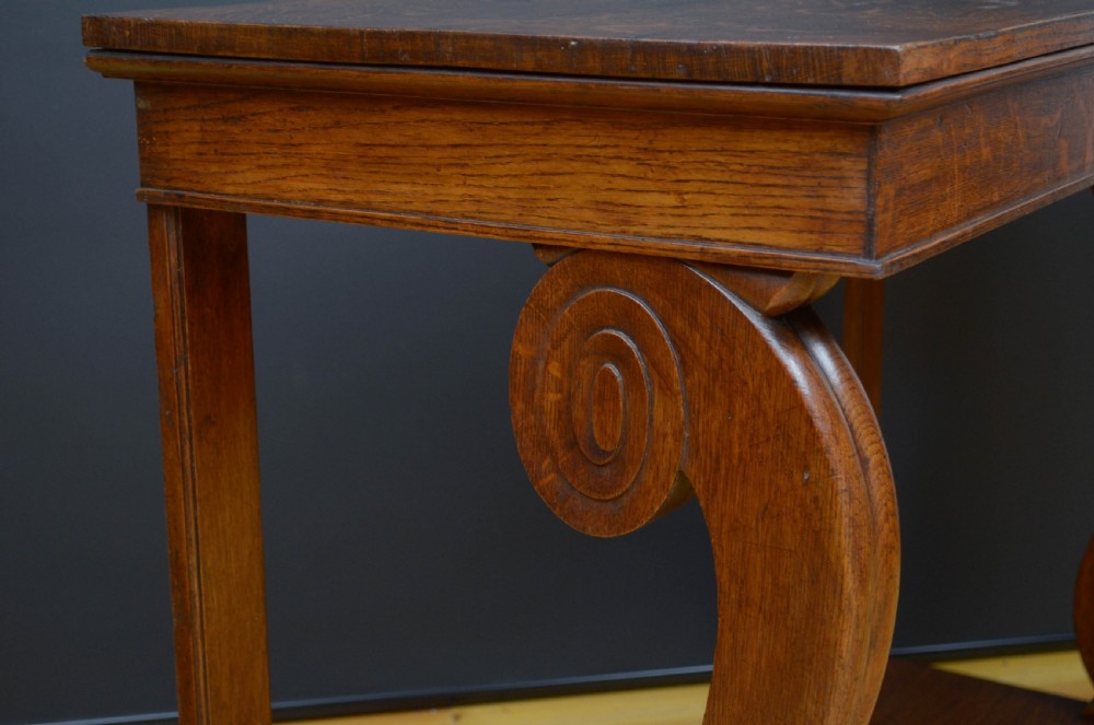 Victorian oak console table featuring a smooth rectangular top, curved scroll legs, and a solid lower plinth base. View VII