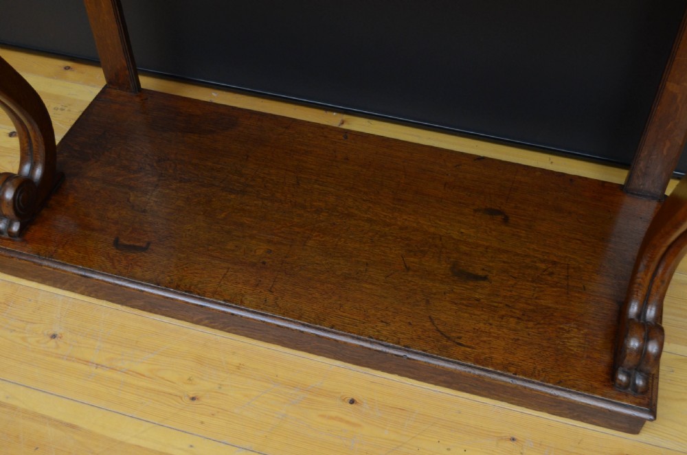 Victorian oak console table featuring a smooth rectangular top, curved scroll legs, and a solid lower plinth base. View IX