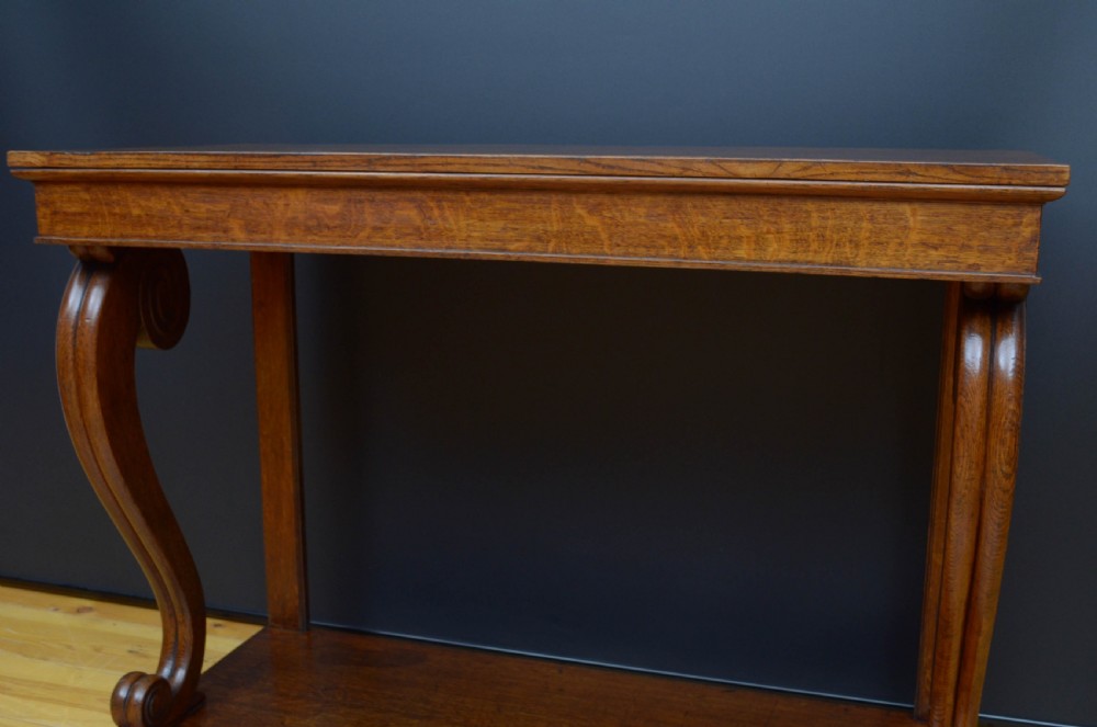 Victorian oak console table featuring a smooth rectangular top, curved scroll legs, and a solid lower plinth base. View XI