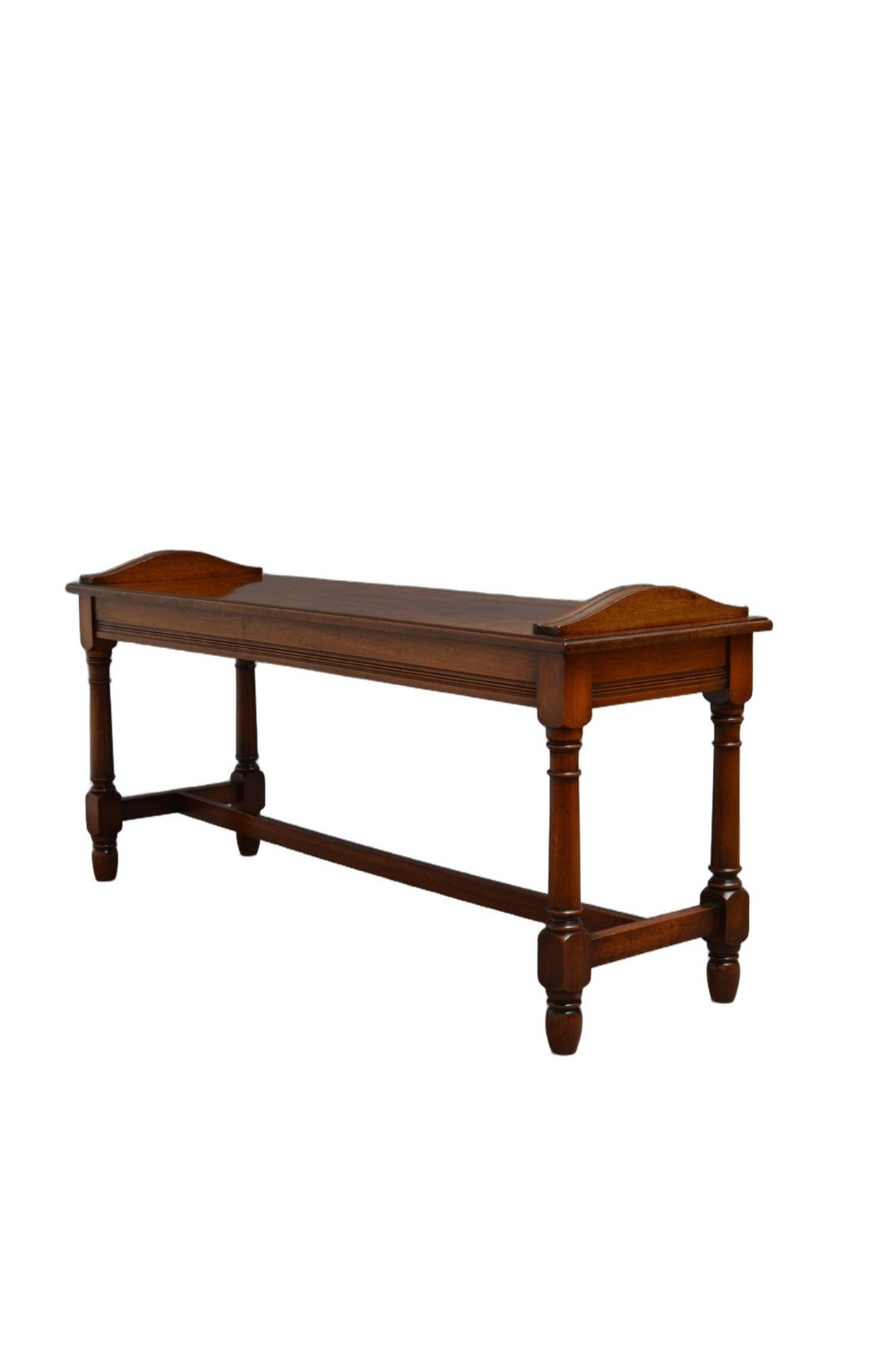 An antique brown walnut hall bench featuring turned legs, an H-stretcher, and raised curved side handles.