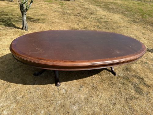 A large Edwardian oval mahogany boardroom table featuring a brown leather inset top supported by twin pedestal legs with splayed feet. View II