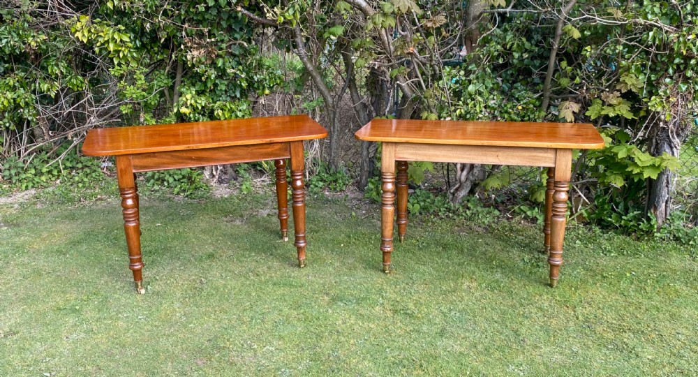 An exceptionally long Early Victorian mahogany extending dining table with turned legs, central pedestal base on scroll feet, and brass castors. View XIII