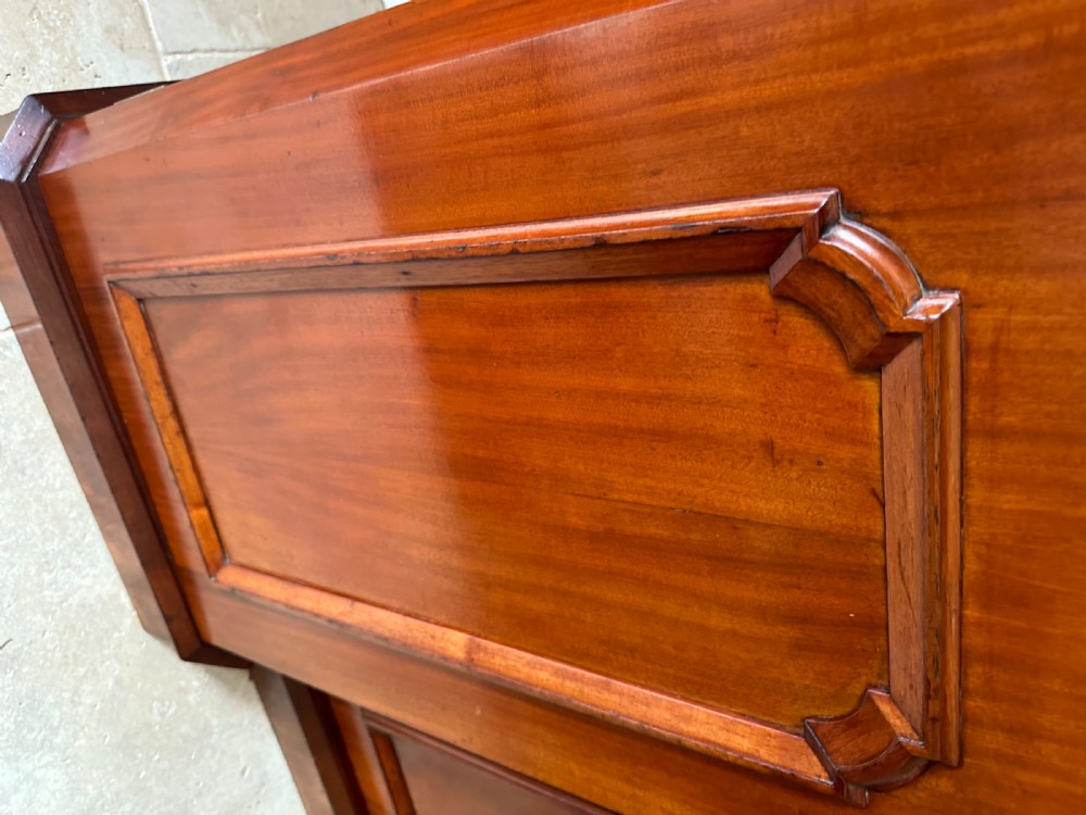 A nineteenth-century Victorian mahogany breakfront sideboard featuring four moulded panel doors and a polished wooden top. View VI